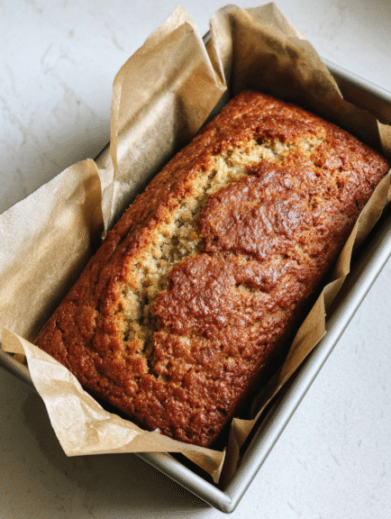 Freshly baked banana bread with cottage cheese in a loaf pan