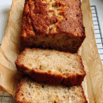 Sliced banana bread with cottage cheese on parchment in loaf pan